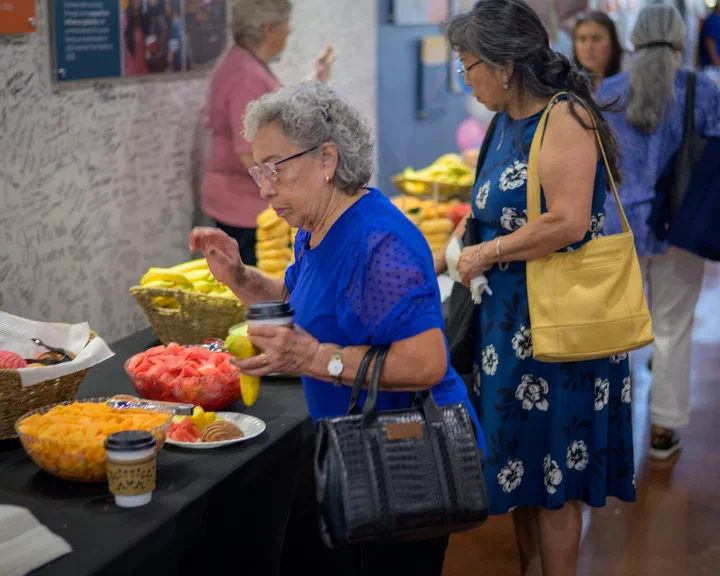 Hermanas sirviéndose fruta en la mesa de la merienda