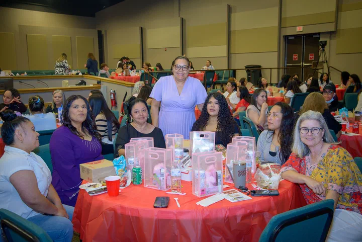 Hermanas sonriendo en una mesa llena de regalos