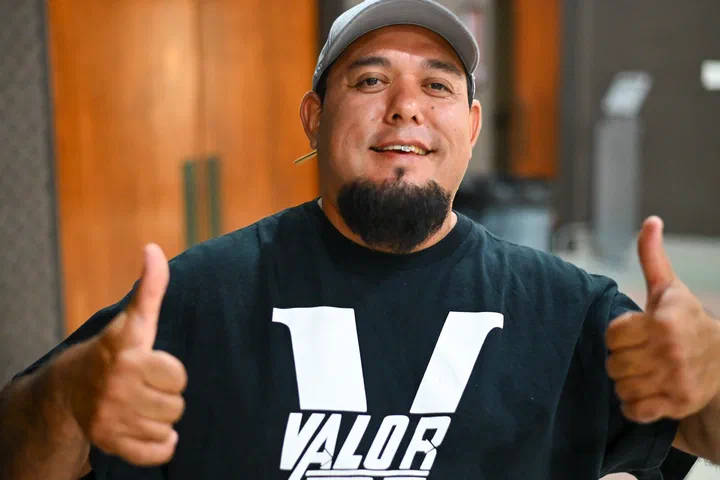 Germán con camisa de Valor y gorra, con los pulgares arriba